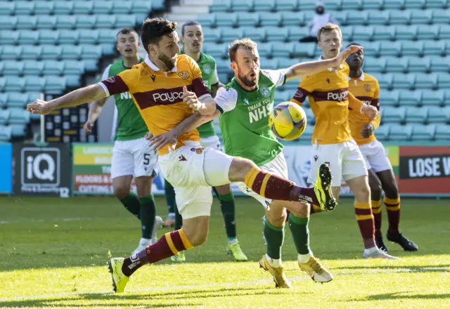 Motherwell's Ricki Lamie (left) tussles with Hibernian's Christian Doidge