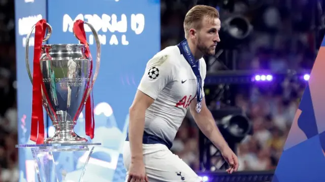 Harry Kane receives his Champions League runner-up medal