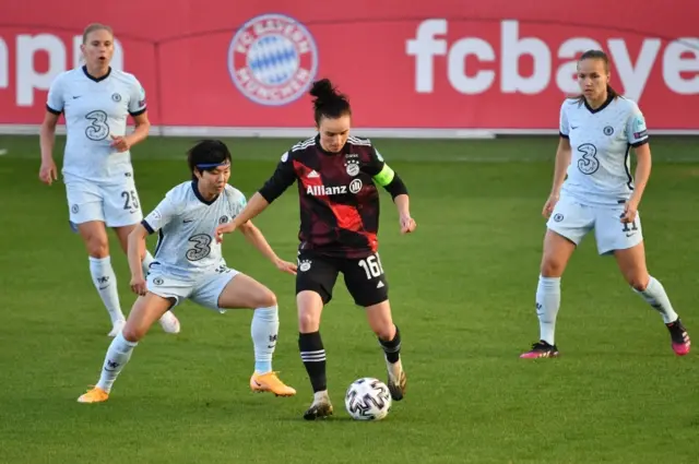 Ji So-yun (second left) battles for the ball