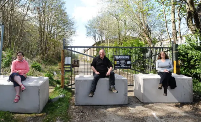 Concrete blocks with councillors sitting on top of them