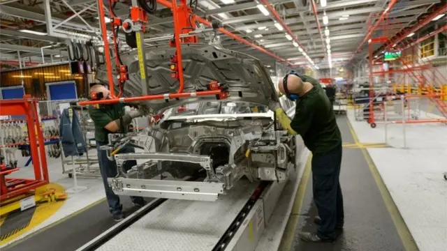 Workers on a JLR assembly line