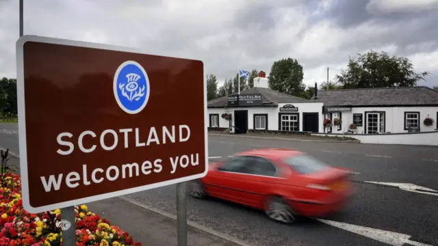 Stock image of a car crossing the border into Scotland