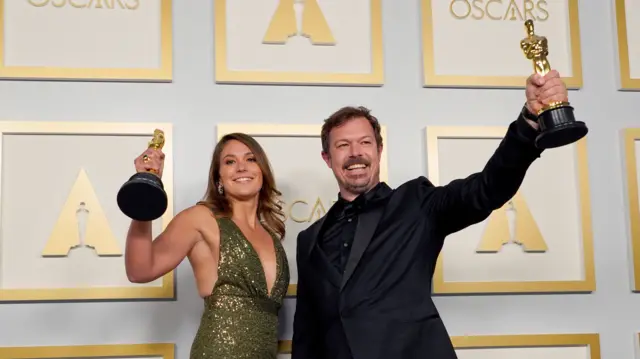 Pippa Ehrlich and James Reed pose in the press room with the award for best documentary feature for My Octopus Teacher at the 93rd annual Academy Awards ceremony at Union Station in Los Angeles