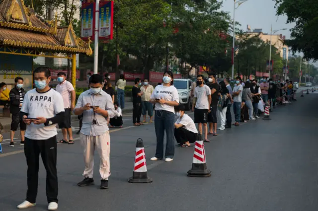 People wait to receive vaccines in Ruili over the weekend