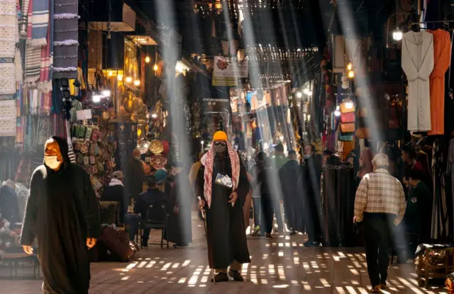 People walk through a souk in Morocco