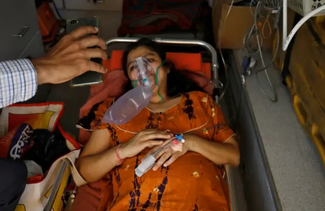 Madhuriben S Parmar speaks to her family on a video call while lying in an ambulance