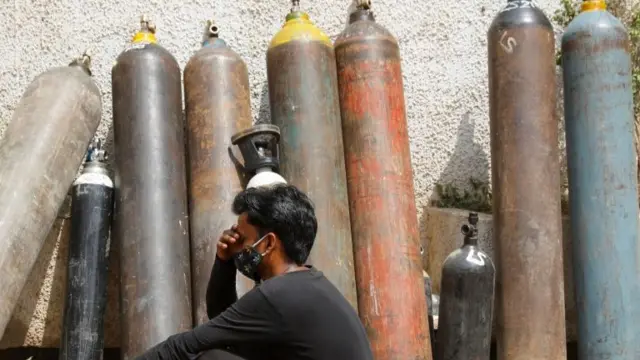 A man waits for an oxygen tank to be filled up