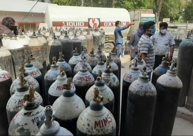 An oxygen tanker replenishing cylinders at a hospital after arriving on an Oxygen Express train