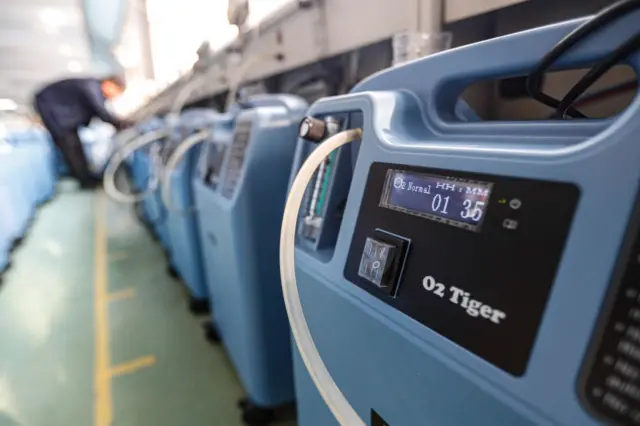 Employees work on the production line of medical oxygen concentrator at a factory of SysMed