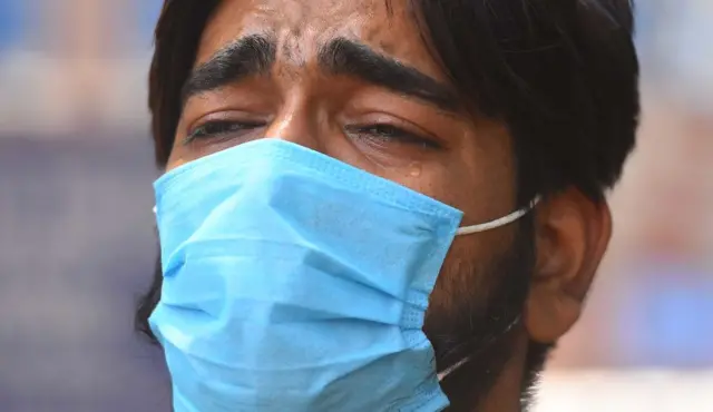 : A relative of Covid-19 patient cries as he waits for admission at Lok Nayak Jai Prakash (LNJP) hospital,