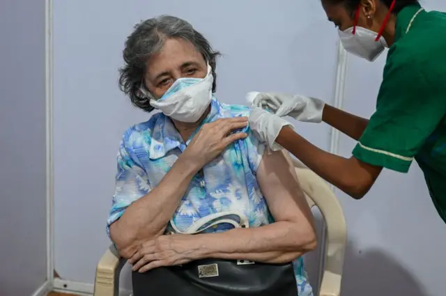 A woman gets vaccinated at a centre in Mumbai