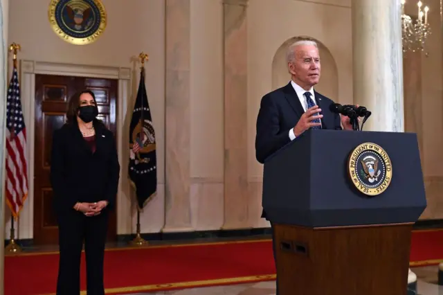 Vice President Kamala Harris (L) listens as US President Joe Biden delivers remarks on the guilty verdict against former policeman Derek Chauvin