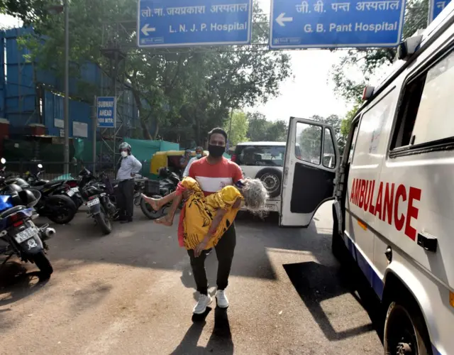 A Covid patient Kuldeep Kumar on oxygen support waits in his car for an admission at Lok Nayak Jai Prakash (LNJP) hospital,