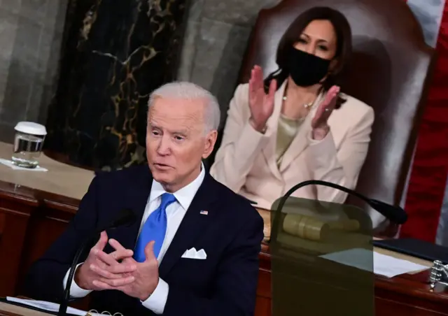 Biden speaks as Harris looks on