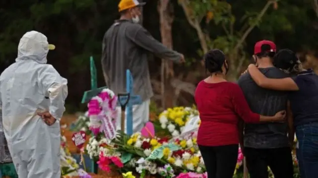 Relatives attend a Covid-19 victim's burial near Manaus, Brazil on 15 April