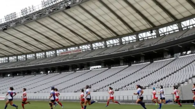 Female players run in the stadium for a test match during the Tokyo 2020 Olympics Rugby test event at Tokyo Stadium, 22 April