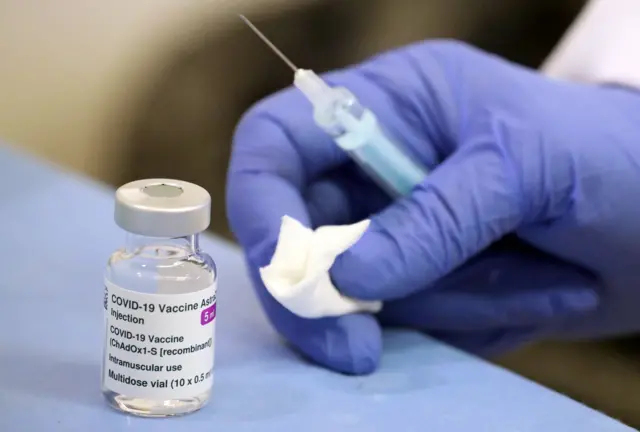 An Oxford-AstraZeneca vaccine is prepared