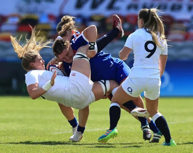 Poppy Cleall of England is tackled by Rose Bernadou