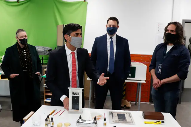 Chancellor of the Exchequer Rishi Sunak wears a mask as he talks to people during a local election campaign visit to Northern School of Art in Hartlepool