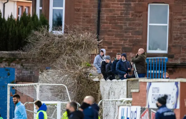 Fans take in Queen of the South v Hibernian at Palmerston Park