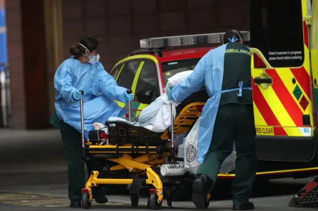 Paramedics pushing a gurney with a patient