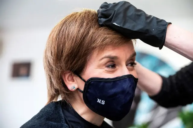 Nicola Sturgeon, wearing a face covering, has her hair coloured and cut at a hairdressers in Edinburgh on Monday