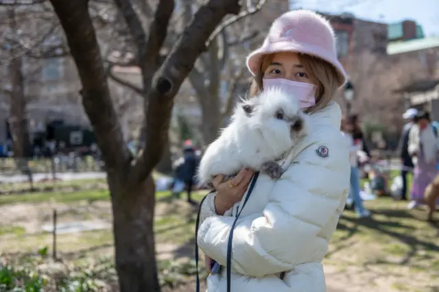 Sylvia poses with her bunny 'Onion' at a 'bunny meet up' in Washington Square Park on Easter weekend on April 03, 2021 in New York City.