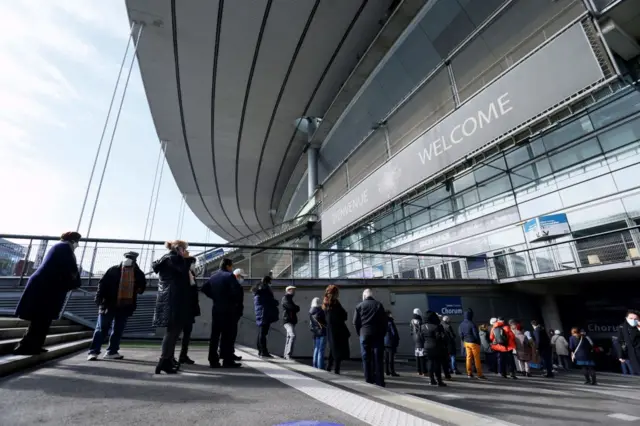 People arrive to be vaccinated against Covid-19 at a vaccination centre set up at the Stade de France outside Paris on 6 April 2021