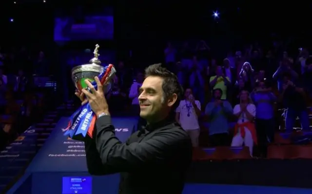 Ronnie O"Sullivan holding the Betfred World Snooker Championship trophy,The Crucible, Sheffield, 16 Aug 2020.