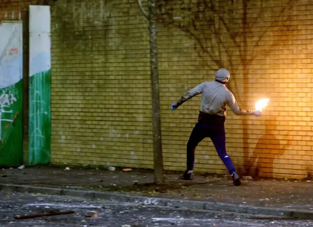 Rioter caught in the act of throwing a petrol bomb on Lanark Way