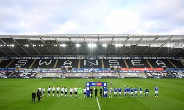 Players line up before kick-off at the Liberty Stadium