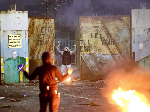 Rioters in a stand off at the peace wall