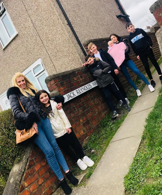 Jack Reynolds' family by the pathway sign