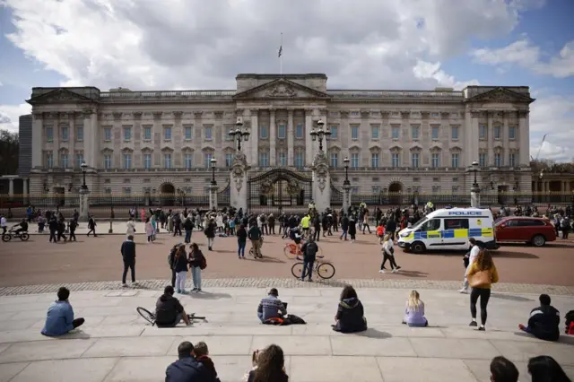 People gather outside Buckingham Palace following the death of Prince Philip