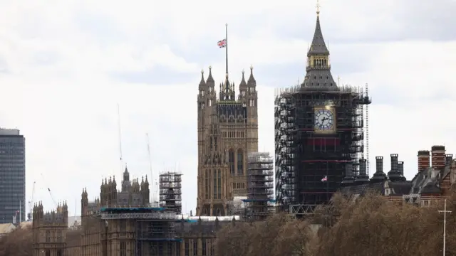 A union jack flag flies half-mast from the Houses of Parliament