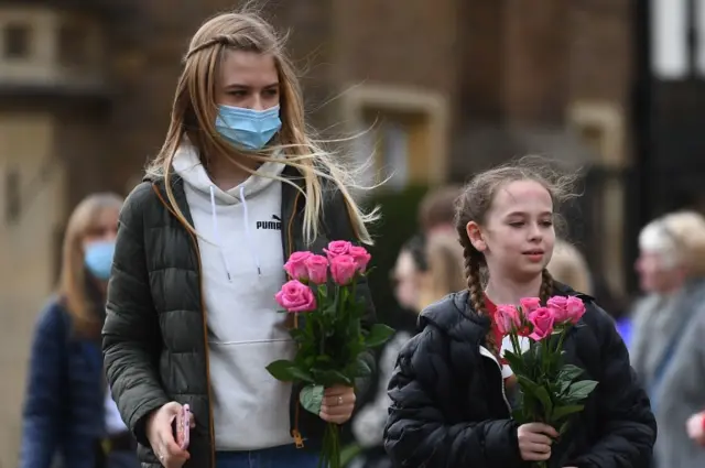 Two girls with flowers outside Windsor Castle