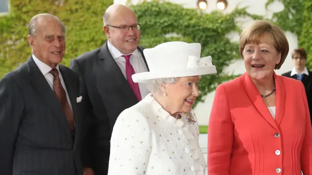 German Chancellor Angela Merkel (R) greets Queen Elizabeth II as Prince Philip, Duke of Edinburgh (L) and Chief of Staff of the German Chancellery Peter Altmaier look on, at the Chancellery on the second day of the royal couples four-day visit to Germany on June 24, 2015 in Berlin, Germany