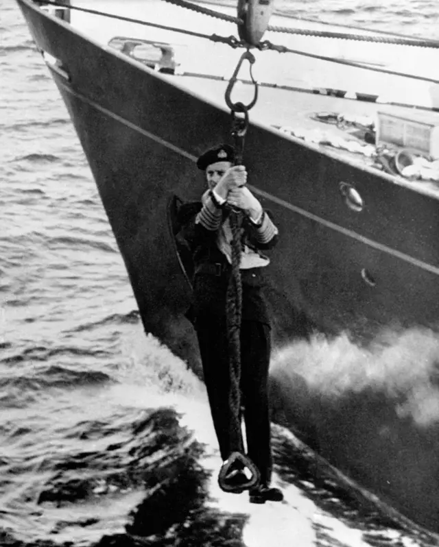 The Duke of Edinburgh transferring ships by jackstay, during the Home Fleet's passage home from Malta after the combined naval exercises in the Mediterranean.