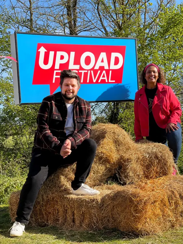 a man and a woman sat on hay bales.