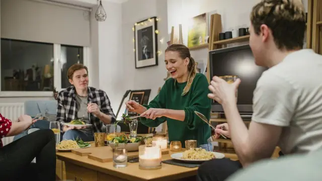 Adults drinking and eating inside a home