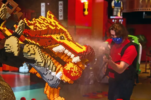 Dylan Sinnott guest experience team leader at the Legoland Discovery Centre in Manchester sprays the rides and models with disinfectant as they make final preparations for re-opening on May 17
