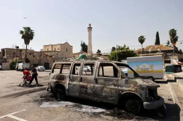 Burned-out vehicle in Lod, central Israel