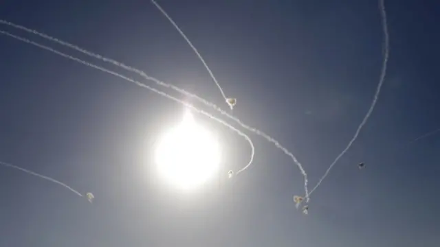 Trails of interceptor missiles fired by Israel's Iron Dome missile defence system near the Gaza border