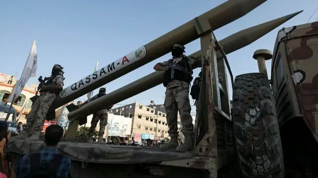 Members of Hamas' military wing display Qassam rockets during a parade in the Gaza Strip