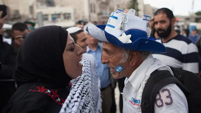 A pro-Palestinian woman and a pro-Israeli man shouting at each other. File photo