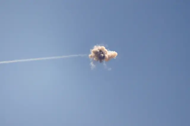 An mid-air explosion is seen from near the Israeli southern city of Sderot after Israel's Iron Dome anti-missile system intercepted a rocket launched from Gaza. Photo: 13 May 2021