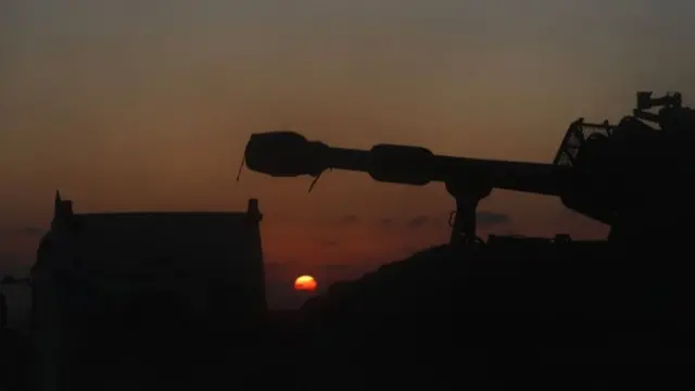 A lorry transporting Israeli self-propelled artillery near the border with Gaza