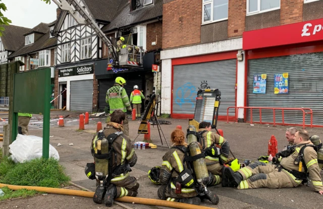 Firefighters relaxing after putting out a fire