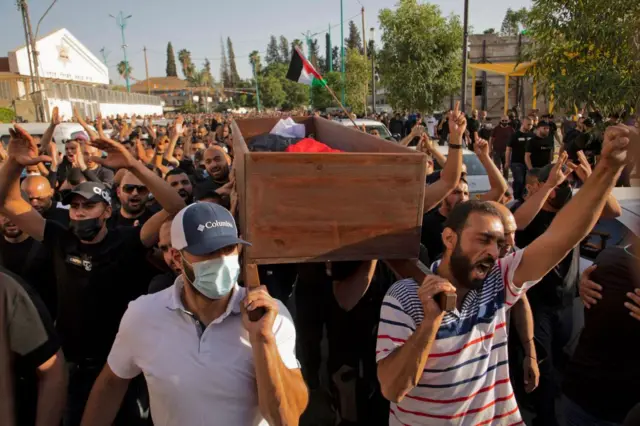 Israeli Arabs carry the coffin of a man shot dead in Lod, May 2021