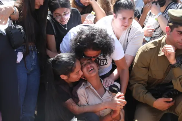 People mourn during the funeral of Israeli soldier Omer Tabib in the northern town of Eliakim. Photo: 13 May 2021